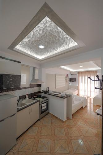 a large kitchen with a large skylight in the ceiling at Hotel Angjelo in Borsh
