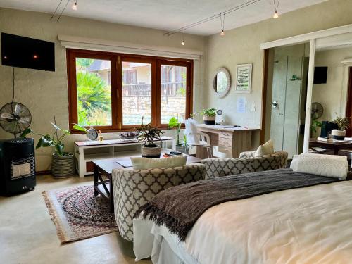 Malinga GuestHouse في Sandton: غرفة نوم مع سرير وغرفة معيشة