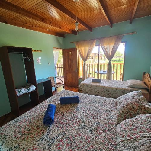 a bedroom with two beds and a mirror on the bed at Hostal Casa los Duendes in San Pedro de Atacama