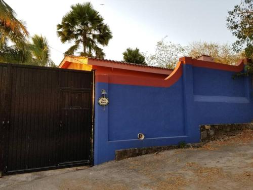 a blue fence with a blue door and a gate at Casa Karina, Spectacular Ocean View Pool Oasis in Aticama