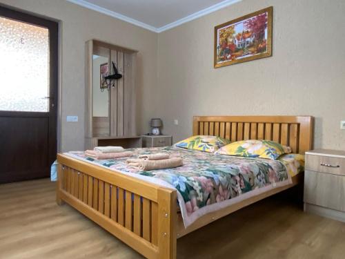 a bedroom with a wooden bed with towels on it at Guesthouse Venera in Mestia