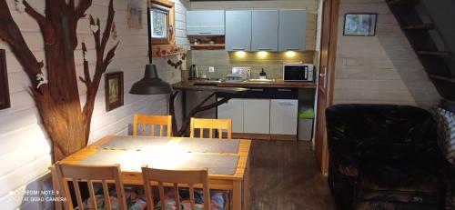 ein Esszimmer und eine Küche in einem winzigen Haus in der Unterkunft Domek przy Rozpadlisku in Podgórzyn
