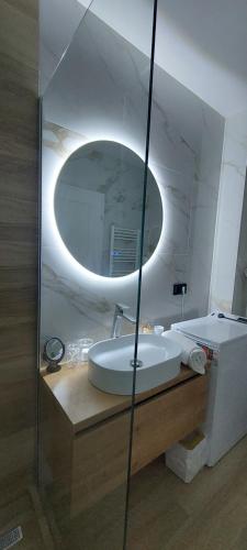 a bathroom with a sink and a mirror at SIA Studio in Oradea