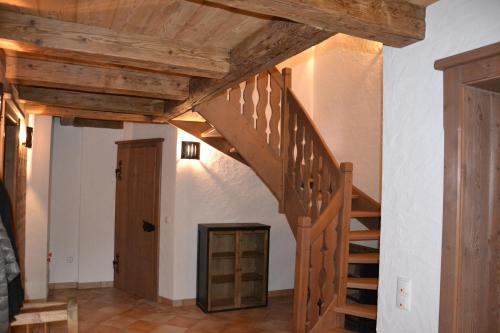 a staircase in a house with wooden ceilings at Ferienhaus Gompitzer in Heiligenblut