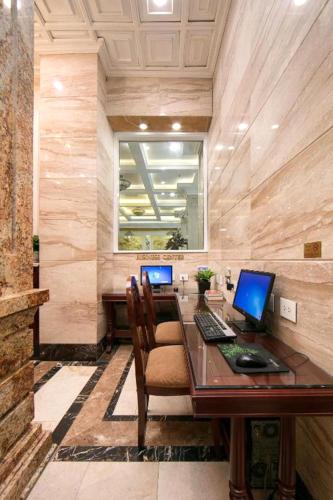 a room with a desk with two computers on it at Thien Thai Hotel & Spa in Hanoi