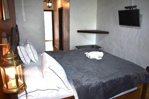 a bedroom with a bed with a towel on it at Porto Grande Hotel & Convention in São Sebastião