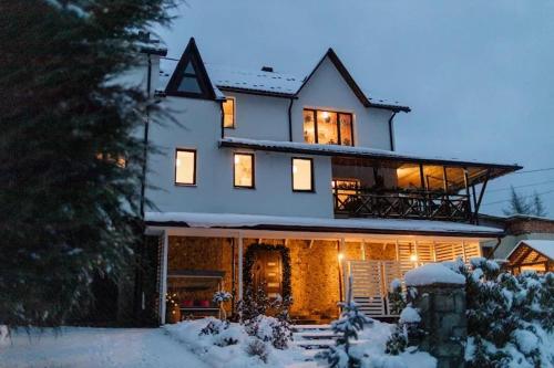 a house with a letter on the roof in the snow at Sadyba Anastasia in Slavske