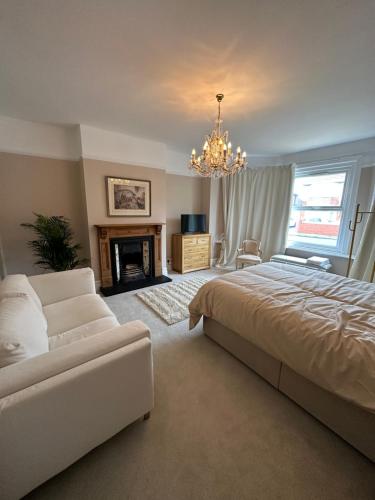 a bedroom with a large bed and a chandelier at Liberty House in Southampton