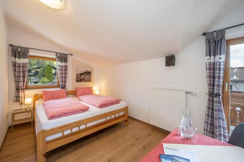 a small bedroom with a bed and a window at Landhaus Aubauerngut in Radstadt