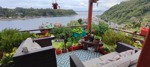 a balcony with chairs and a view of a river at Habitación con vista al mar in Puerto Montt