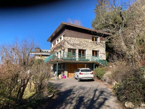 a car parked in front of a stone house at Chambre privée dans Maison Familiale in Veyrier-du-Lac