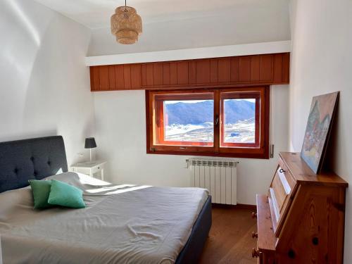 a bedroom with a bed and a large window at Brown bear home in Roccaraso