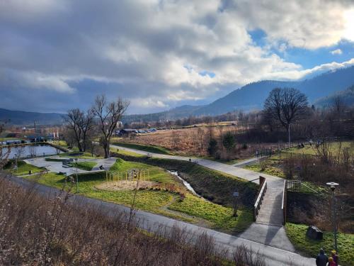 a view of a park with mountains in the background at Apartament Dominik in Głuszyca