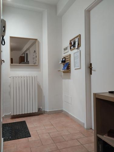 a room with a hallway with a mirror and a radiator at 37 Nodi in Ancona