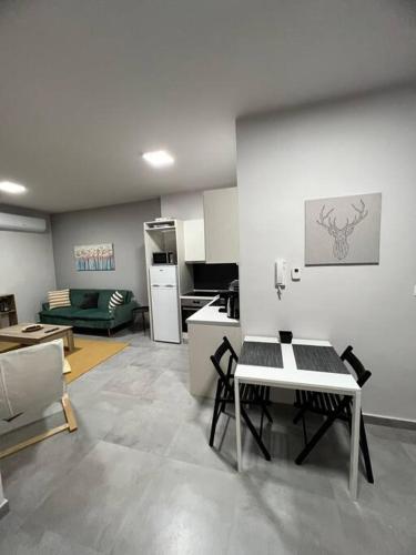 a living room with a table and a kitchen at Othonos 10 str. apartment. in Tríkala