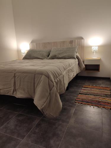 a bedroom with a large bed and a rug at Cabañas Olluhuasi in Valle Hermoso