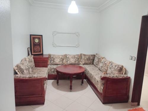 a living room with a couch and a table at SkyRise 1 Khemisset 2 bedrooms in Khemisset