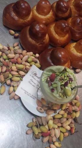 a table with donuts and nuts and a plate of doughnuts at Dimora dell'Etna in Randazzo