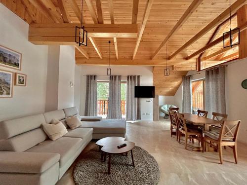 a living room with a couch and a table at ALPS Apartments in Kranjska Gora
