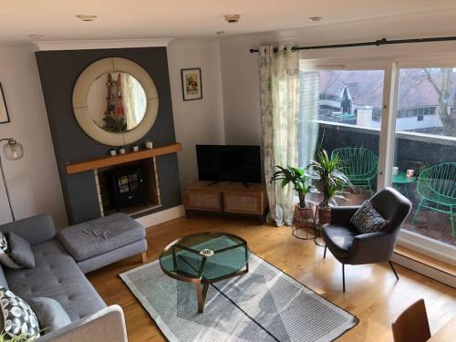 a living room with a couch and a table at Apartment with balcony West Bridgford in Nottingham