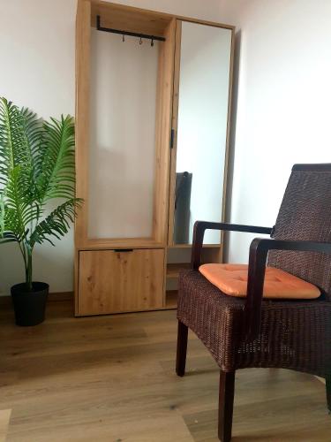 a room with a chair and a potted plant at Auszeit in Plauen