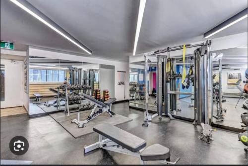 une salle de sport avec plusieurs tapis de course et machines dans l'établissement Hello,CRESCENT, à Montréal