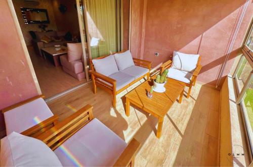 an overhead view of a living room with a table and chairs at Luxurious Stay at Prestigia Golf Marrakech with Golf Course, Pool, and Breathtaking Atlas Mountains View in Marrakech