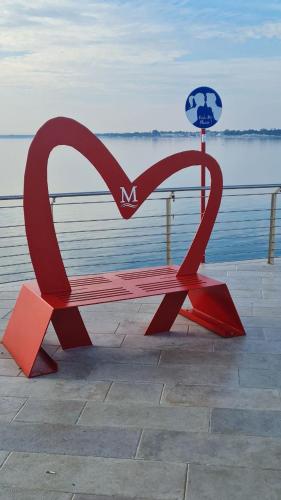 a red bench in the shape of a heart at CASA VACANZA PARADISO in Manfredonia