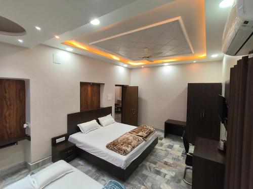 a bedroom with a bed and a tv in it at Mandakini Homestay in Varanasi