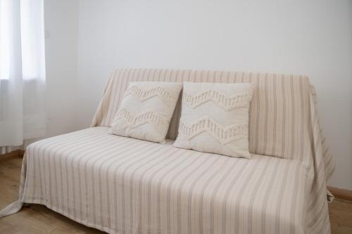 a bed with white sheets and pillows on it at Ferienwohnung Rheinauen in Germersheim