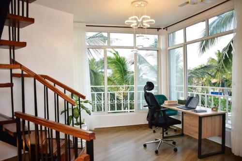 een bureau met een stoel en ramen bij Zuri Luxe 2BR Penthouse- Silversands Beach Malindi in Malindi