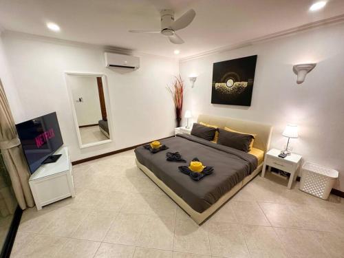 a bedroom with a large bed and a mirror at View Talay Villas - Luxury, 1 Bedroom - private pool villa, 500m from Jomtien beach - VTV 57 in Jomtien Beach