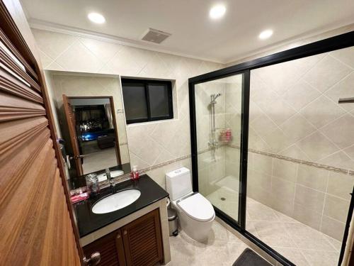 a bathroom with a toilet and a sink and a shower at View Talay Villas - Luxury, 1 Bedroom - private pool villa, 500m from Jomtien beach - VTV 57 in Jomtien Beach