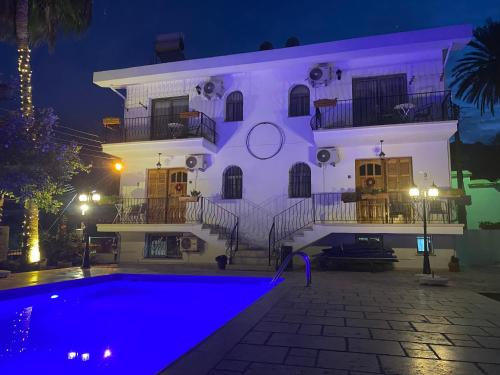 a building with a pool in front of it at night at Templos Homes in Kérynia