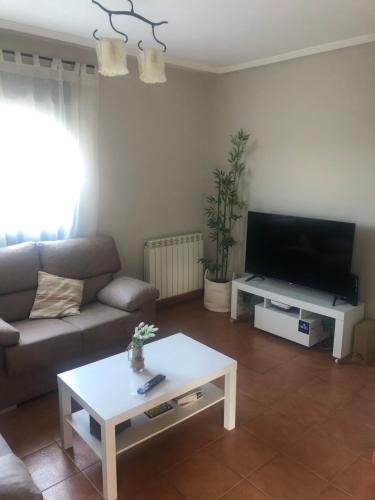 a living room with a couch and a coffee table at La Casa del Ciprés in Aldeamayor de San Martín