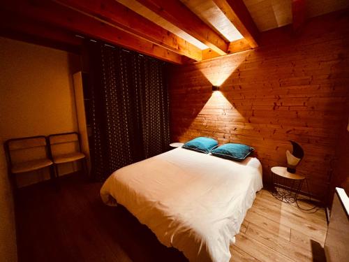 a bedroom with a bed and a brick wall at Gite du moulin in Montgesoye