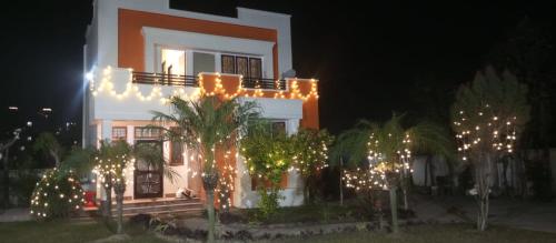 a house with christmas lights in front of it at The Beatrix Resort & Wellness in Lucknow