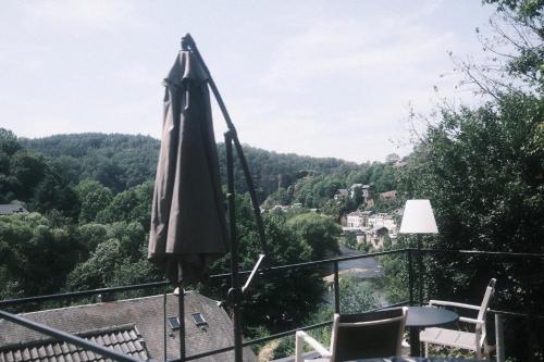 an umbrella sitting on top of a balcony at Le Rotche III in La Roche-en-Ardenne