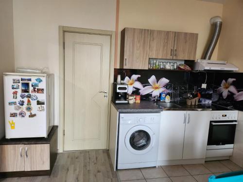 a kitchen with a white refrigerator and a washing machine at Best apartment- airport in Sofia