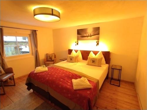 a hotel room with a bed and a window at Arlberghaus Rocks in Flirsch