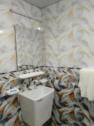 a bathroom with a white toilet in a room at Travel lodge clifton in Karachi