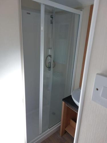 a bathroom with a shower and a sink at Southview Holiday Park Skegness - Upgraded Caravan - Unica in Skegness