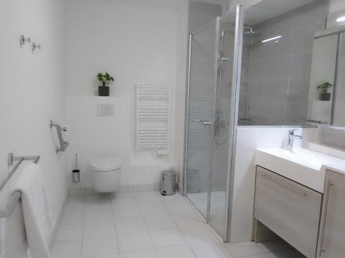 a bathroom with a shower and a toilet and a sink at Domitys L'Ellipse in Paris