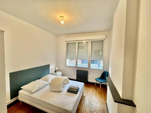 une chambre avec un lit et une chaise dedans dans l'établissement Le Lovely avec parking, à Amiens