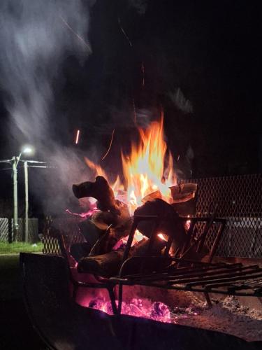 a large fire in a fire pit at night at PIRIA in Playa Hermosa