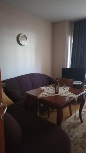 a living room with a couch and a table at Predela 1 in Bansko