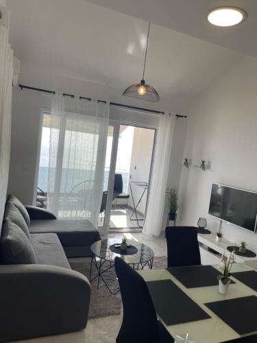 a living room with a couch and a table at Apartments Beverly in Omiš