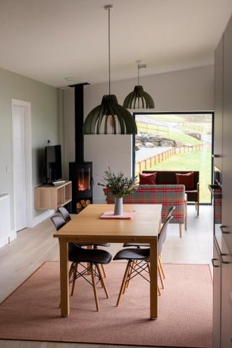a living room with a wooden table and chairs at Number Five in Aberfeldy