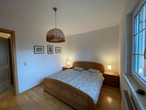 a bedroom with a bed with two lamps on it at Bungalow in ruhiger Lage in Dietachdorf