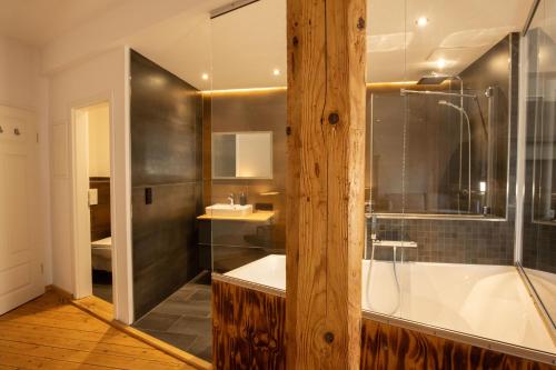 a bathroom with a shower and a tub and a sink at Loft Apartment mit großer Badewanne B in Mügeln
